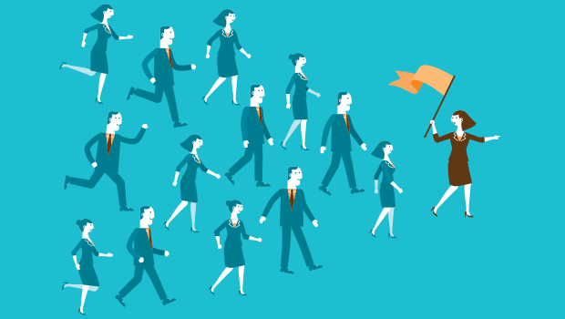 people following one person holding a orange flag